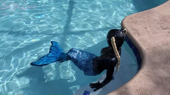 The Latex Mermaid Swimming In The Pool