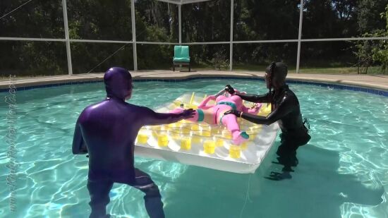 TS Nyxi And Rubber_Jeff "The Dildostick For Rubberdoll Lara On The Pool Float"